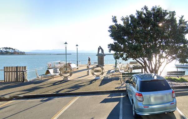 A car parked on a road by a body of water

Description automatically generated with low confidence